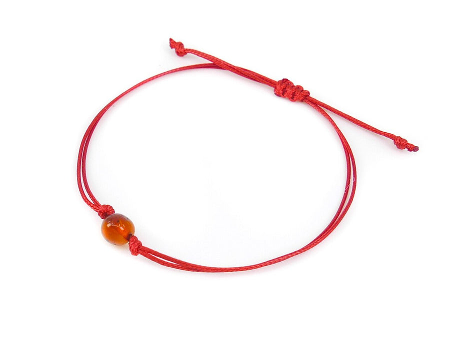 PULSERA DE HILO ROJO CON ÁMBAR BÁLTICO PULIDO EN COLOR COÑAC