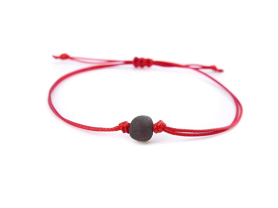 PULSERA DE HILO ROJO CON ÁMBAR BÁLTICO CRUDO EN COLOR CEREZA OSCURA