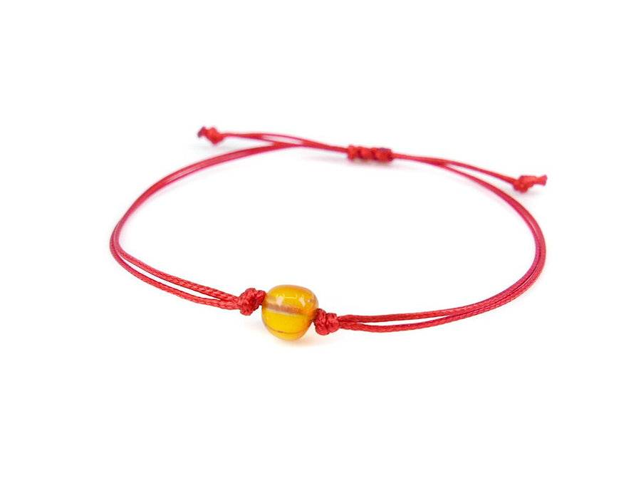 PULSERA DE HILO ROJO CON ÁMBAR BÁLTICO PULIDO EN COLOR MIEL